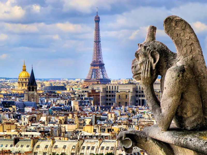 A stone chimera looking over Paris from Notre-Dame